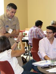 Dr. Irby (R) discusses flooding issues with fellow attendees during a meeting of the Virginia Coastal Policy Clinic in 2016.