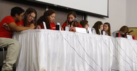 The teams from Fauquier High (L, in red) and CBGS-Warsaw, Team A (R, in grey) compete during the match. Photo by Vivian Hollingsworth, VASG intern.