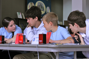 Members of the team from Fredericksburg Academy consult before answering a question.