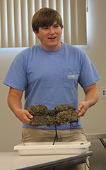 VIMS intern Tyler Chandler presents his summer research project to the audience at the Eastern Shore Lab.