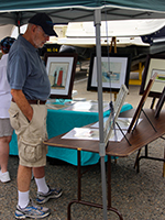 VIMS Emeritus Professor Mo Lynch checks out some of the Bay-inspired artwork for sale at the festival.