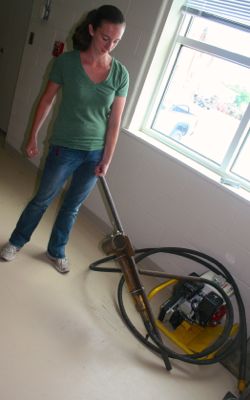 Mary Goodwyn, Sediment Program Manager at the Virginia Institute of Marine Science, with the vibracorer that is used to take sediment cores from the seafloor.